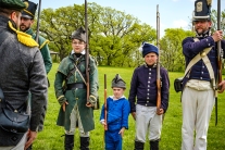 Sergeant of the Guard Stephen Baker inspects rifle brigade members from left Andrew Gahagen, Liam Baker, Isac Baker, Caleb Baker and Ben Godfrey. Fort Atkinson Living History.