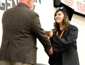 Hannah Conklin receives her diploma from school board president Jon Genoways.