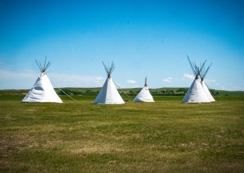 Tepees stand outside the back gate of Fort Union where Indian encampments might have been located. The back gate was the exit point to the trails and prairie beyond the fort.