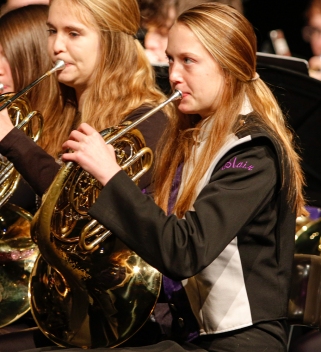 Sophomore Caitlyn Haggerstrom plays French horn in the 9-10 band during the winter concert in the Lela Neve Auditorium.